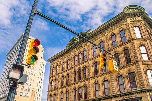 grand rapids architectural photography of traffic lights near beige painted establishment architecture